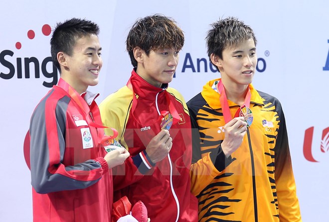 Quý Phước (giữa) giành huy chương vàng và phá kỷ lục SEA Games. (Ảnh: Quốc Khánh/TTXVN)