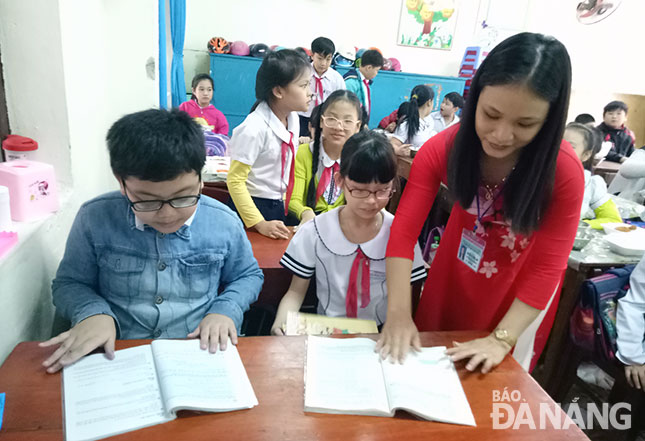 Việc áp dụng Thông tư 22 giúp giáo viên giảm tải nỗi lo hoàn thành nhiều loại sổ sách. Trong ảnh: Một giờ học của học sinh Trường tiểu học Lê Quý Đôn.