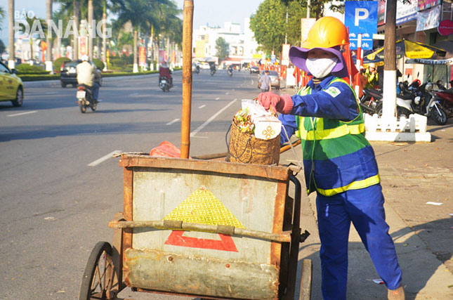 Công nhân Công ty CP Môi trường đô thị Đà Nẵng đang thu gom rác thải, không để rác tồn đọng trong dịp Tết.