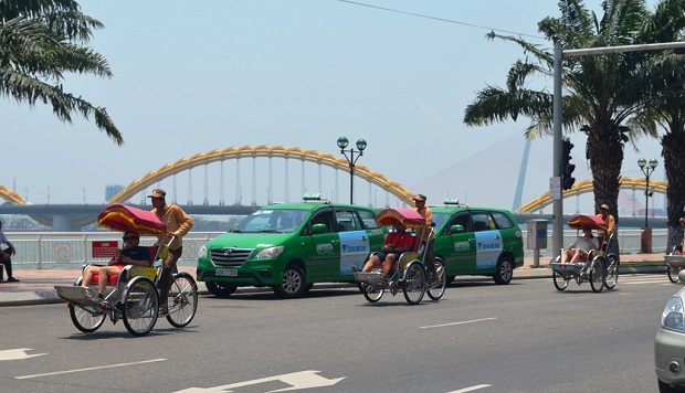 Foreign visitors enjoying a city tour by cyclo