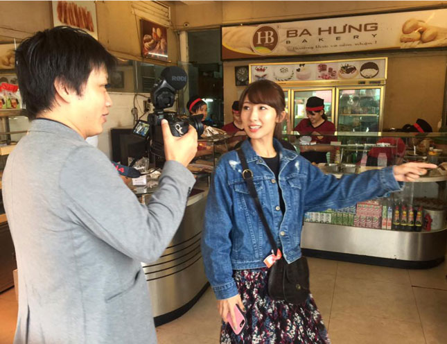   Japanese filmtrip visitors surveying  a local shopping area