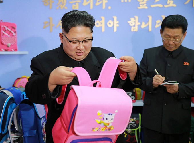 Ông Kim Jong-un xem một chiếc balô dành cho bé gái khi tới thăm một nhà máy sản xuất cặp và túi xách. Ảnh: Reuters.