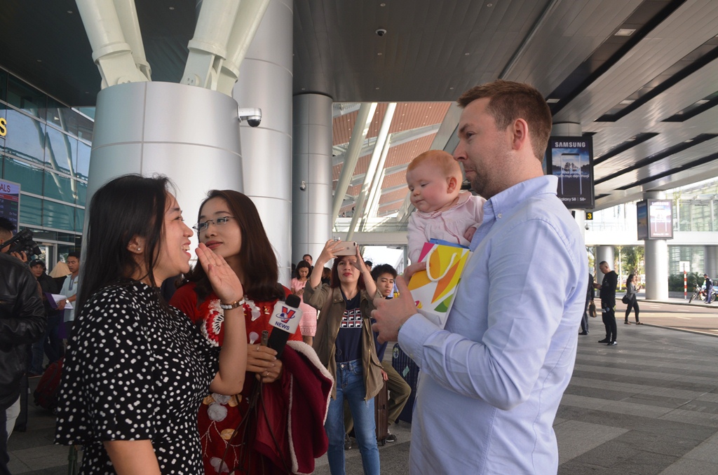 Mr Ross HellAby (right) and his family members being warmly received at the airport