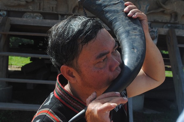 A Cơ Tu man plays a buffalo horn -- a musical intrument of the ethnic group 