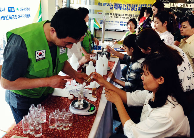  Visitors being guided about how to make facial cleanser and mineral water facial spray, and receiving free face care products at a skincare booth