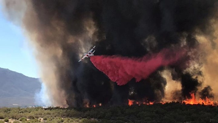 Máy bay thả hóa chất dập lửa gần tuyến đường Benton và Crams Cover ở hạt Riverside, California, ngày 4/7/2018.