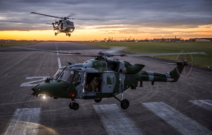Hai chiếc trực thăng đa nhiệm Lynx của RAF hạ cánh trong ánh hoàng hôn ở căn cứ Odiham.