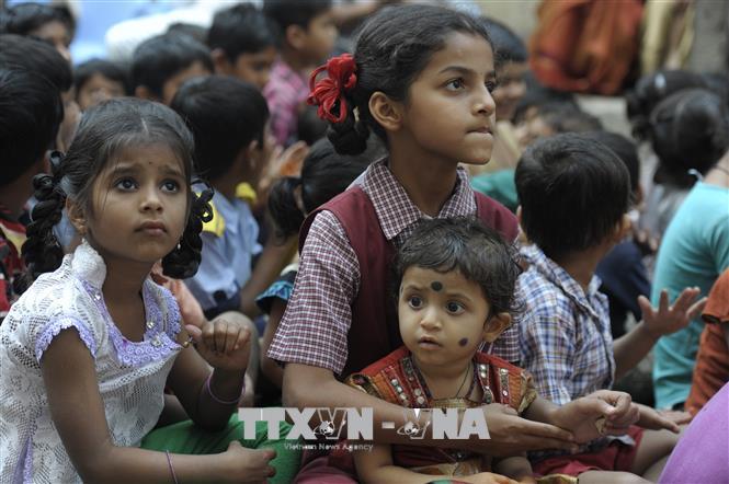 Các bé gái Ấn Độ chờ để được nhận sách miễn phí tại Palamuru Basthi, Hyderabad. AFP/TTXVN