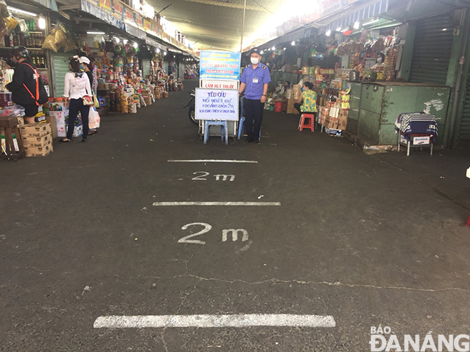 White markings on the ground in the Con Market to help remind customers of the 2-m social distancing recommendations. 
