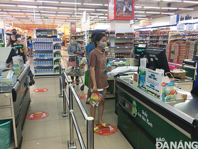 Shoppers at the Co.opmart Supermarket are required to keep at least 2 metres away from others