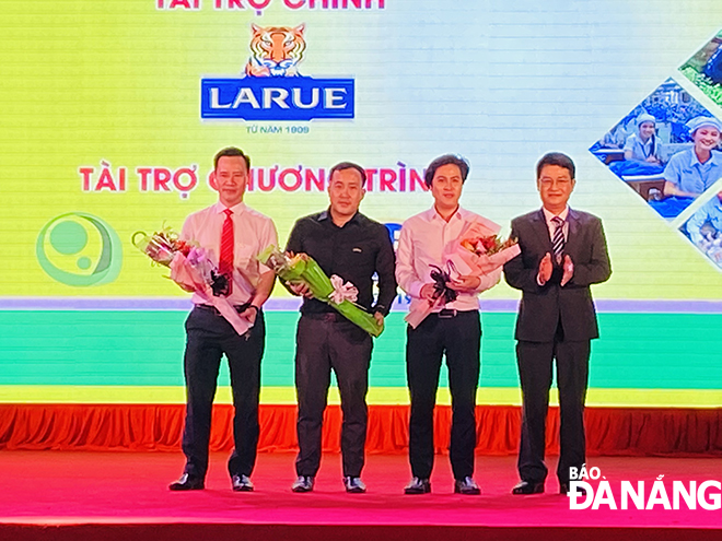 Ông Phạm Văn Hải, Giám đốc Thương mại Vùng Trung Trung Bộ (đầu tiên bên trái) nhận hoa cảm ơn của Ban tổ chức hội chợ EWEC dành cho nhà tài trợ chính.