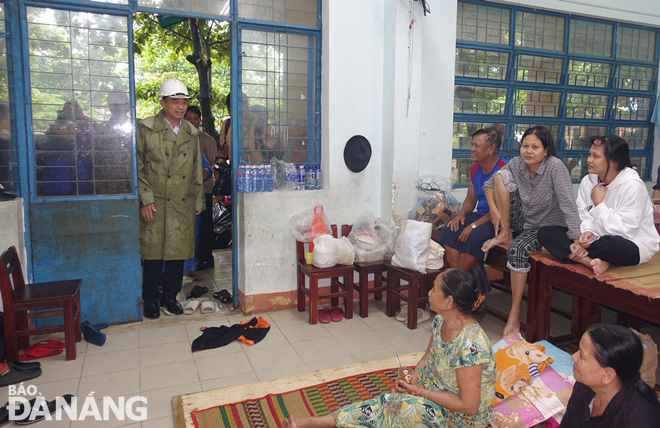 Chủ tịch UBND thành phố Lê Trung Chinh (trái) thăm hỏi và động viên nhân dân yên tâm ở lại nơi sơ tán tại một điểm sơ tán ở quận Sơn Trà. Ảnh: HOÀNG HIỆP