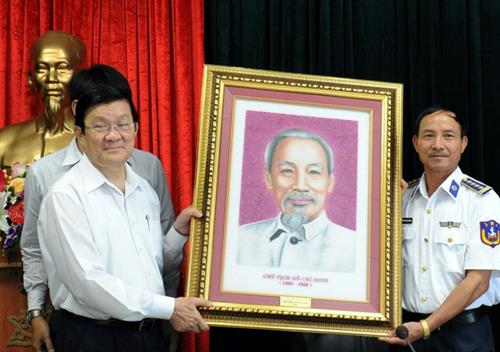 Presenting a portrait of the late President Ho Chi Minh to a representative from the Marine Police Agency Zone 2.