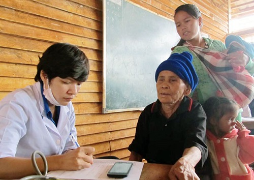 A young doctor writing a prescription for a Laotian patient