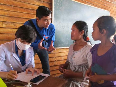  A young doctor writing a prescription for patients in Salavan Province