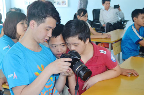  A young student talking with some of the AO children