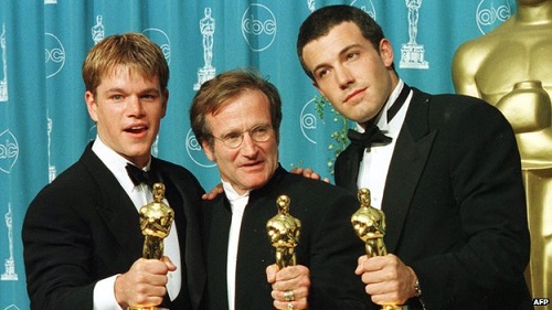 Williams (middle) with his Oscar, flanked by co-stars Matt Damon and Ben Affleck