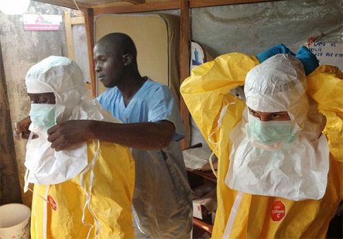  Medical workers in a West African country being equipped with personal protective clothing