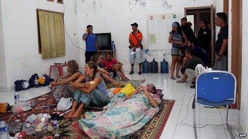 A group of survivors rest at a house near the Indonesian town of Bima following the sinking on Saturday