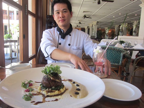 Chef of the Café Indochine Restaurant, Doan Van Tuan, presenting his “bo nau cham” (slow cooked beef)