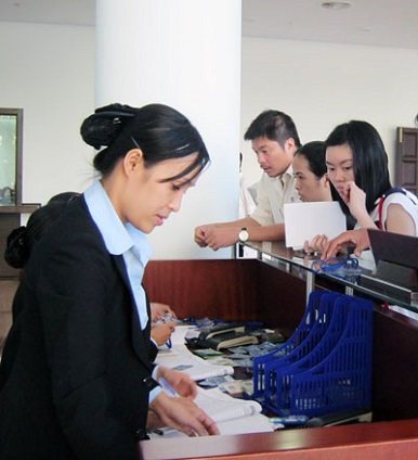    A receptionist receiving visitors to the centre.