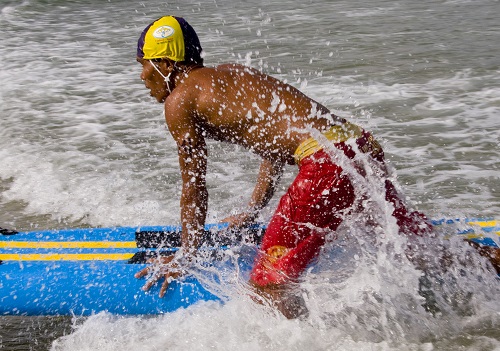   A lifeguard quickly responds to help a swimmer in distress.