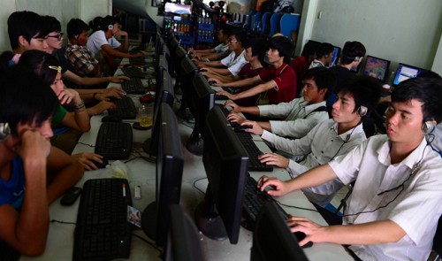 Young people are shown at Internet café in Ho Chi Minh City in this photo illustration.