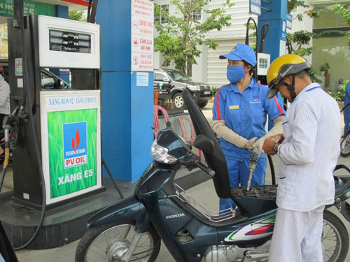 A local customer has his motorbike filled up 