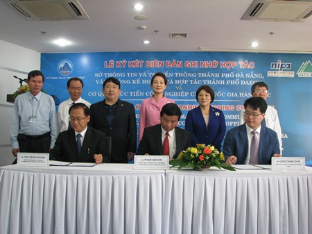 Representatives from three agencies signing the MoU