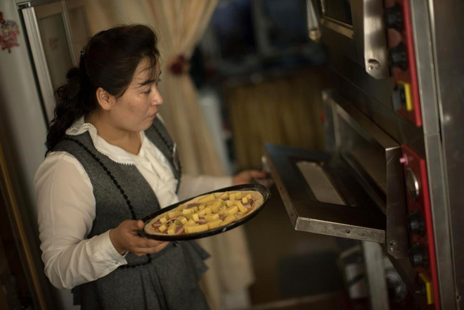 Nhân viên phục vụ tại một nhà hàng Italy ở Bình Nhưỡng đang nướng bánh pizza.