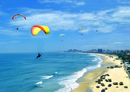 An exciting paragliding display on a local beach