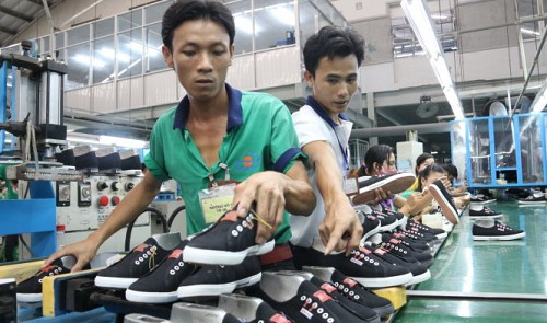 Employees of shoemaker Dong Hung Co. work at the company's plant in Binh Duong Province, located in southern Viet Nam.