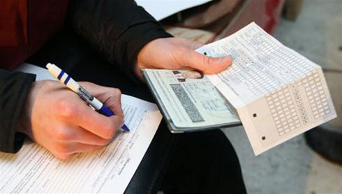 A person is seen holding a passport in this photo illustration.