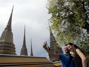 Tourists take a selfie at Wat Pho temple in Bangkok 