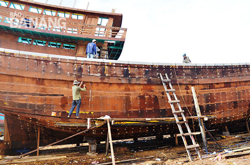 A wooden-hulled fishing boat under construction