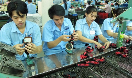 Workers are pictured on the production line at a footwear company in Ho Chi Minh City in this photo illustration.