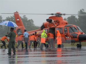 Rescue team carries the body of a passenger to a helicopter on January 1 