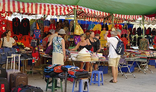 European visitors boarding cruise ship Crystal Symphony choosing Vietnamese handicrafts at Phu Huu Port in Ho Chi Minh City