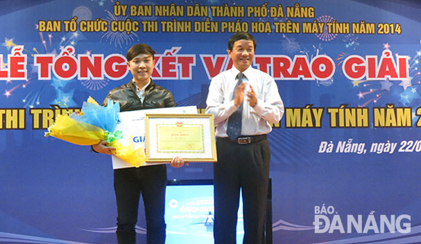 Trần Anh Tuấn (trái) trên bục nhận giải nhất cuộc thi trình diễn pháo hoa trên máy tính 2014 với tác phẩm “Phù Đổng Thiên Vương”. Ảnh: T.T