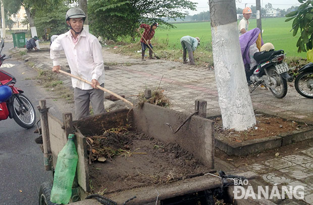 Người dân xã Hòa Châu, huyện Hòa Vang tham gia dọn vệ sinh trên tuyến quốc lộ 1A, đoạn đi qua địa bàn xã.