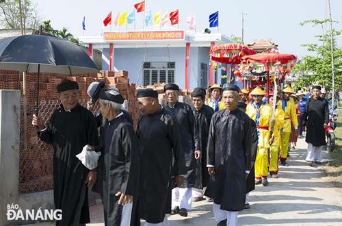 Local senior citizens in traditional costume in a procession of deities. 