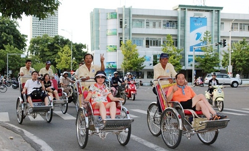 International visitors enjoying a city tour by cyclo