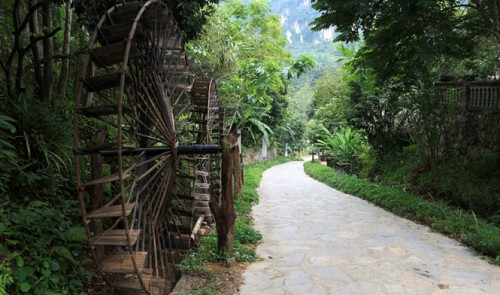 The large wooden water reels are positioned along the entrance to the Muong Culture Space Museum