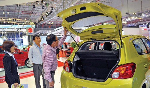 A file photo shows a customer looking at an imported car at a dealership in Ho Chi Minh City.