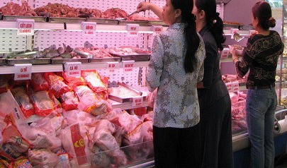 Shoppers choose frozen chicken at a supermarket in Ho Chi Minh City.