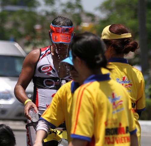 Local volunteers provide water for an athlete along the way