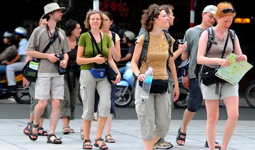 Foreign tourists are seen walking on a street in Ho Chi Minh City