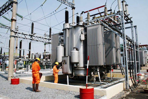 Local electricity workers involved in maintenance work at a transformer station