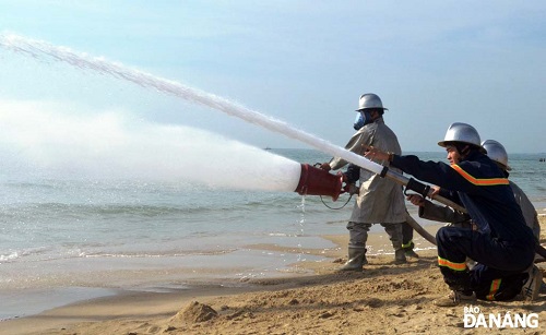          Spraying water and chemical foam to prevent a fire