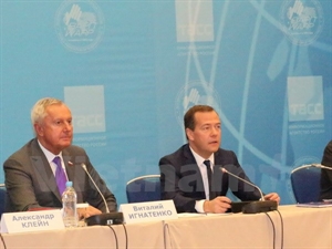 Russian Prime Minister Dmitry Medvedev (R) speaks at the 17th World Congress of Russian Press 